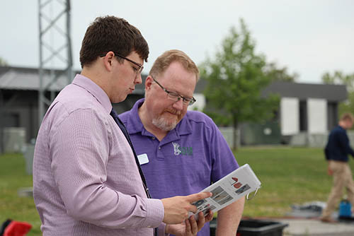 two men looking at a blueprint